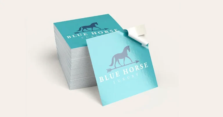 Tall stack of square teal logo stickers with one corner peeled back