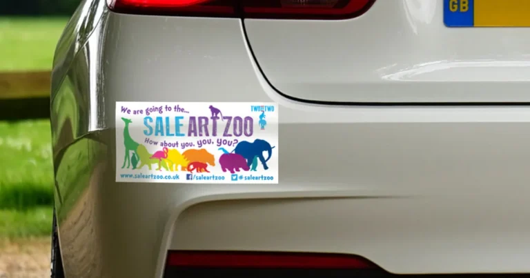 Colorful rectangular bumper sticker on the back of a white car