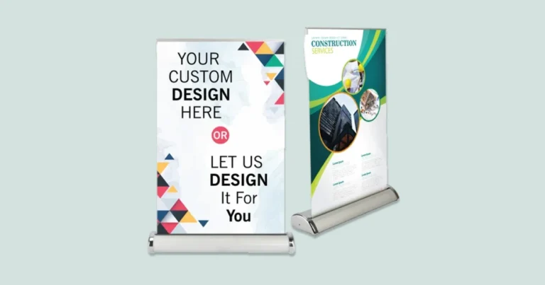 Two tabletop roll-up banners, one with a custom design and one for construction services
