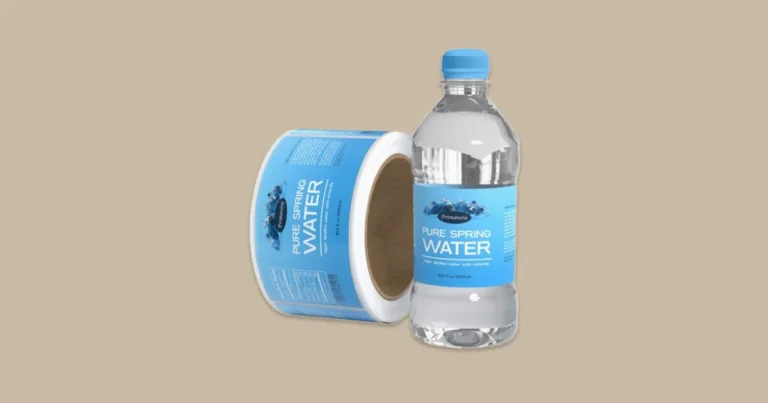 Water bottle with a blue spring water label beside a roll of matching labels