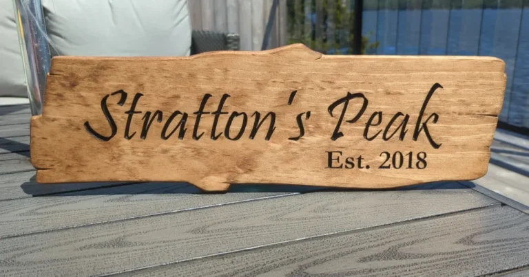 Rustic wooden sign carved with "Stratton's Peak, Est. 2018"