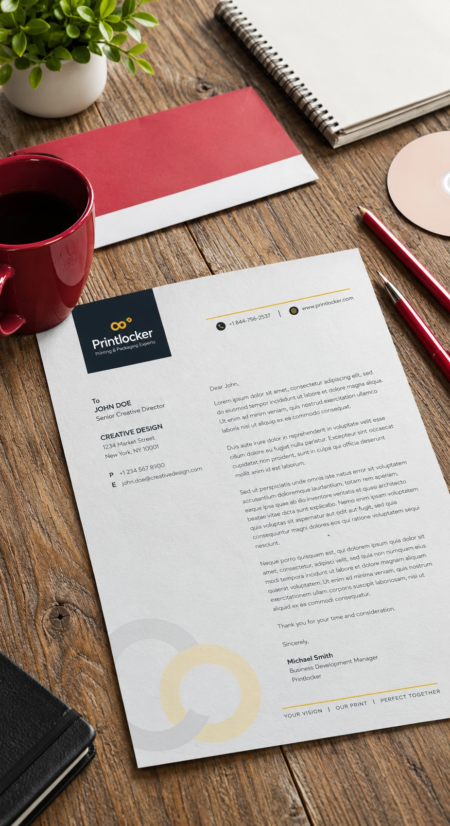 PrintLocker branded letterhead with a typed business letter beside a red envelope on a wooden desk