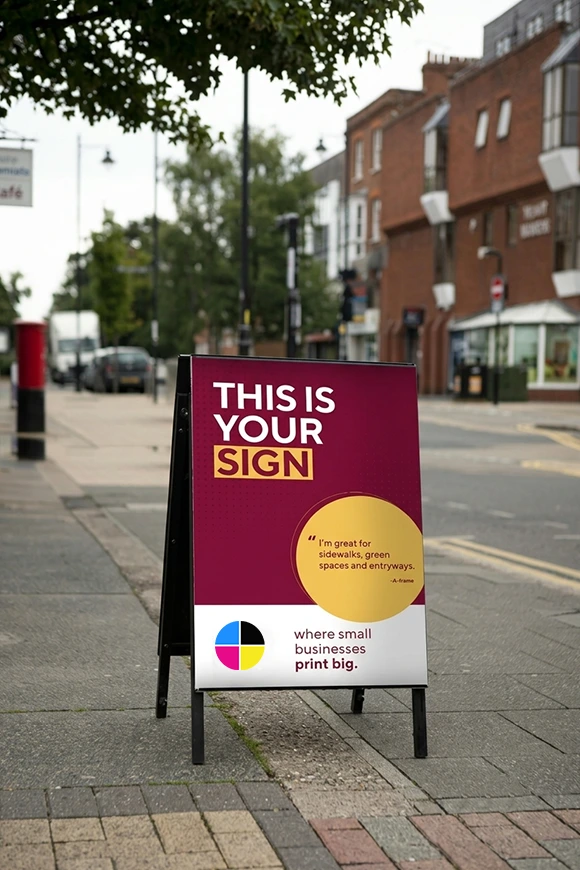 A-frame sidewalk sign reading "This is your sign" on a high street